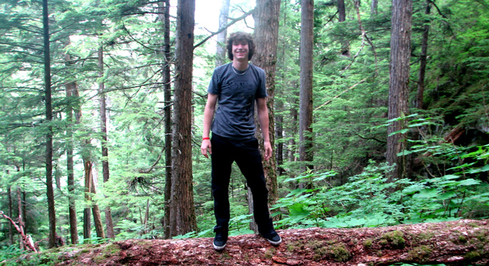 Spencer balances on a tree trunk.